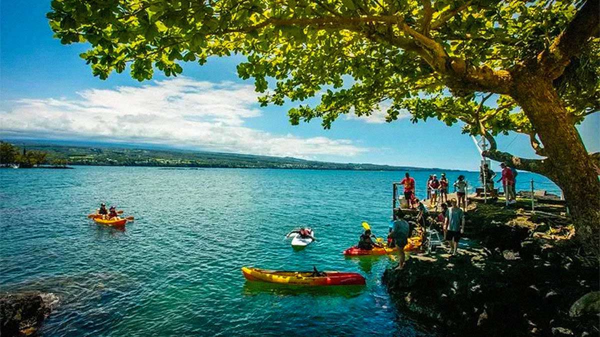 a group of people in hilo bay waterfall